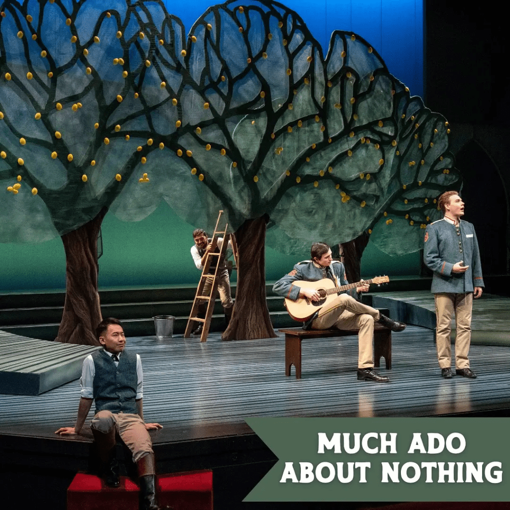 A stage set for a production of 'Much Ado About Nothing,' featuring large decorative trees and actors engaged in various activities, including one playing guitar and another standing and speaking. The backdrop is bright and colorful, enhancing the whimsical atmosphere of the performance.