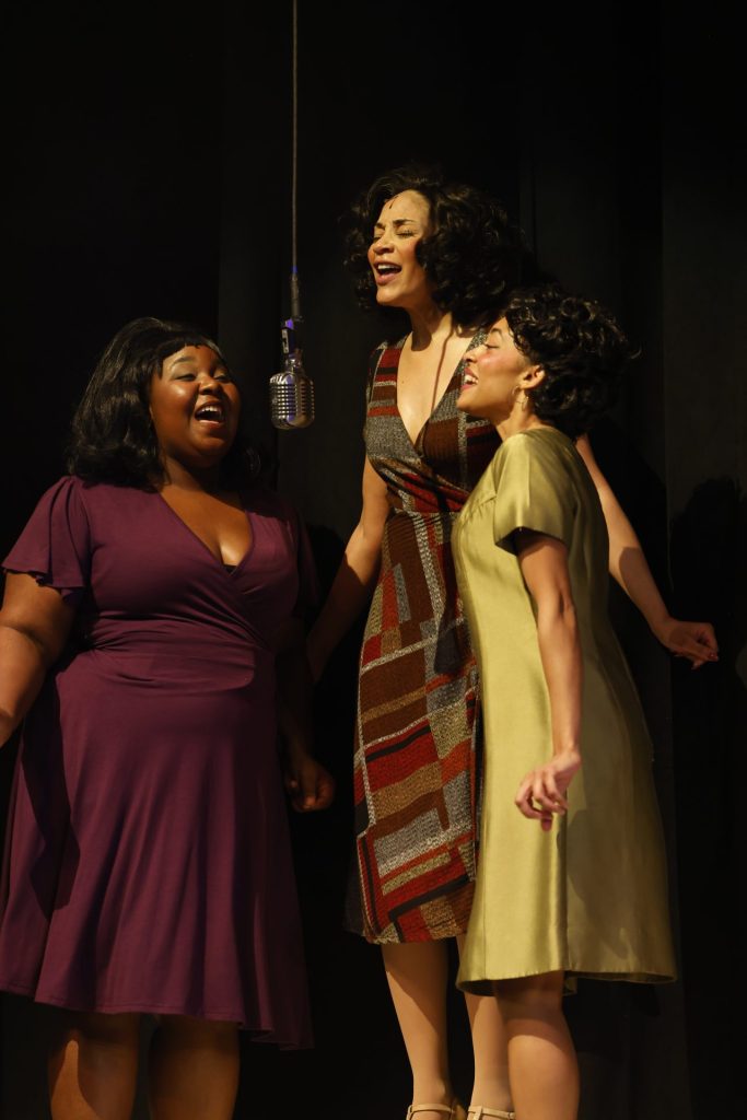 "Dreamgirls" at The Grand: Where Black Brilliance Takes Center Stage 4 Quesley Soto, Kandyce Marie, & Darby Mest standing around a mic singing