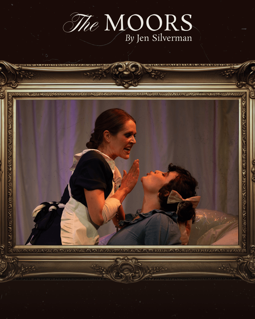 A Funny, Bloody, Queer Gothic: Voodoo Theatre Company’s "The Moors" Bites Back 2 A dramatic scene from _The Moors_ featuring two characters. One character in a maid's outfit expresses intense emotion towards another character, who appears to be seated and looks up in surprise. The background is a soft, light-colored curtain, enhancing the theatrical atmosphere.