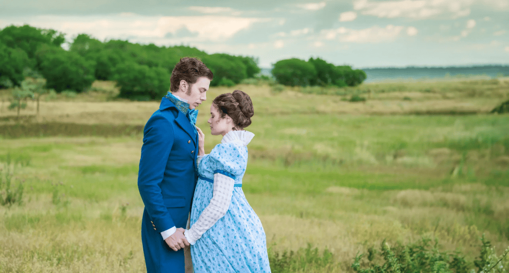 Listening to Mrs. Bennet: Larson’s Pride and Prejudice at The Ruth 2 A couple in 19th-century attire shares an intimate moment in a lush, green landscape.
